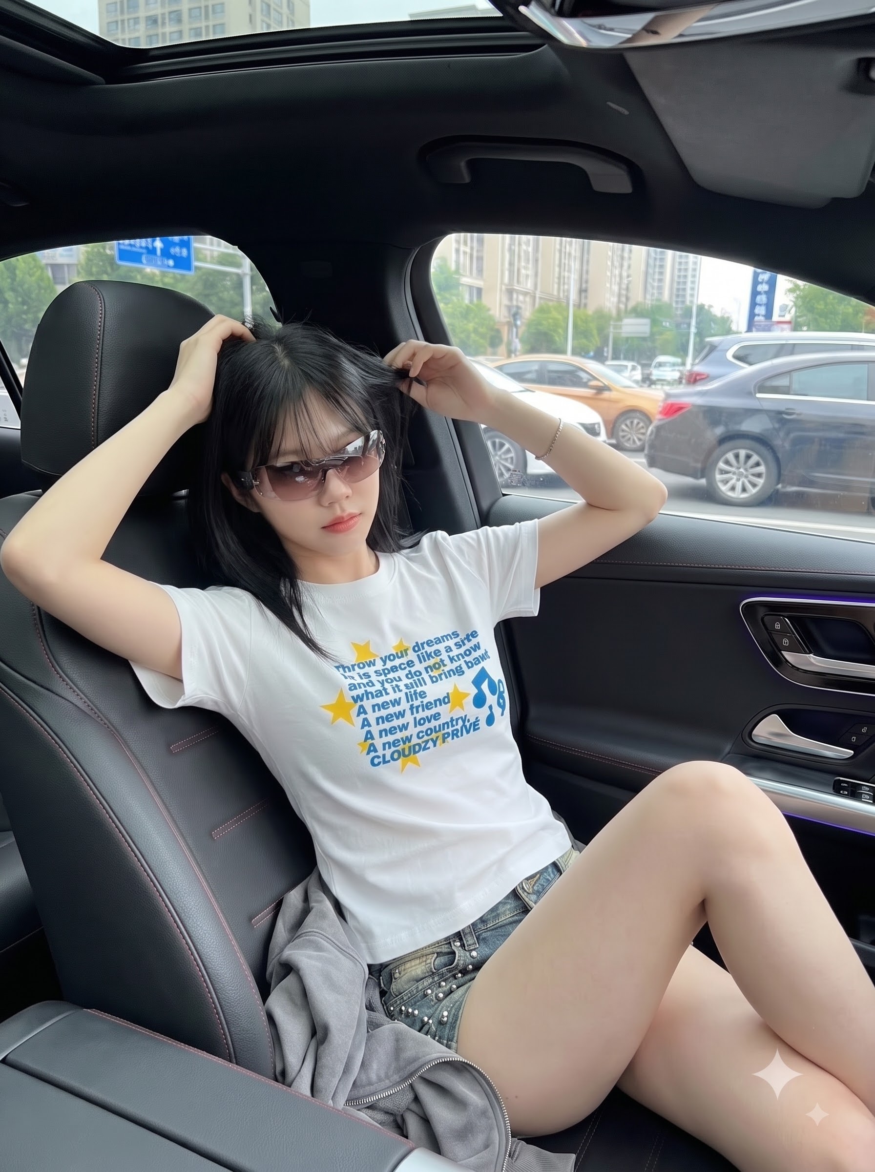B—VERSE white graphic tee styled inside a car